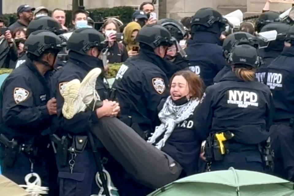 A protester is lifted out of the encampment after the NYPD swarmed Columbia. Robert Miller for NY Post