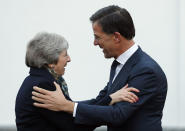 British Prime Minister Theresa May is greeted by Dutch Prime Minister Mark Rutte upon her arrival in The Hague, Netherlands, Tuesday, Dec. 11, 2018. Facing almost certain defeat, Prime Minister May on Monday postponed a vote in Parliament on her Brexit deal, saying she would go back to European Union leaders to seek changes to the divorce agreement. (AP Photo/Peter Dejong)