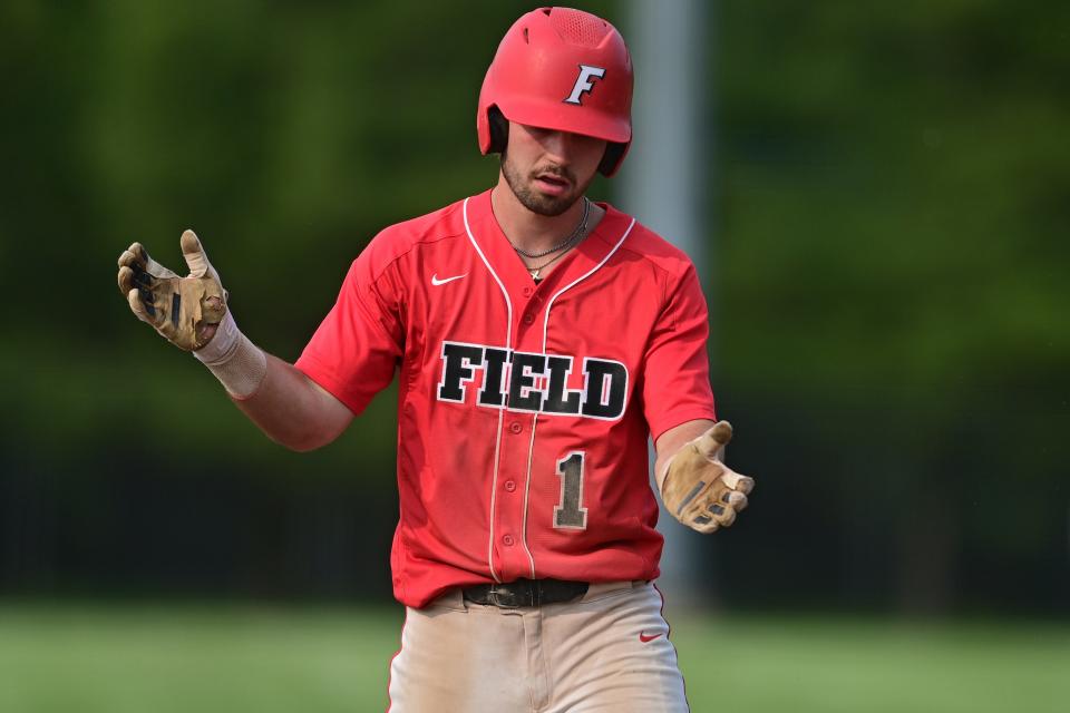 Field's Garit Greene celebrates after hitting a single during their OHSAA tournament game against Ursuline Monday night at Cane Park in Struthers, Ohio.