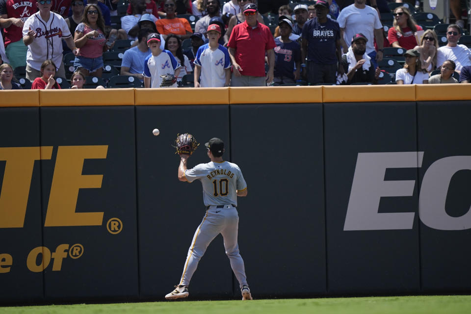 Pittsburgh Pirates outfielder Bryan Reynolds (10) catches a ball hit by Atlanta Braves' Marcell Ozuna (20) in the first inning of a baseball game against the Pittsburgh Pirates, Sunday, June 30, 2024, in Atlanta. (AP Photo/Brynn Anderson)