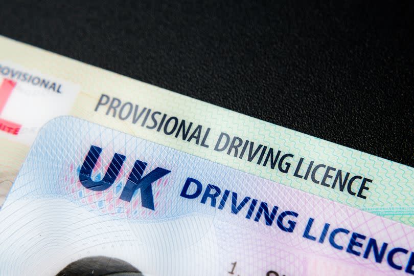 UK Driving Licence. Provisional and Full licence cards isolated on dark background