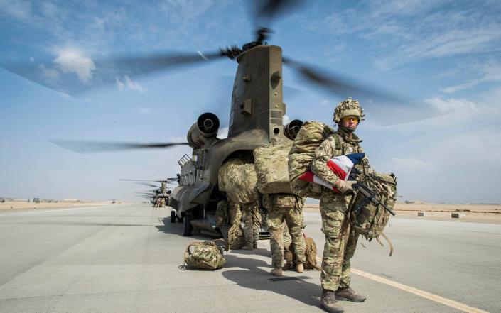 Wing Commander Matt Radnall, Officer Commanding 7 Force Protection Wing, carries a carefully folded Union Flag under his arm and back home to the UK - Ben Birchall