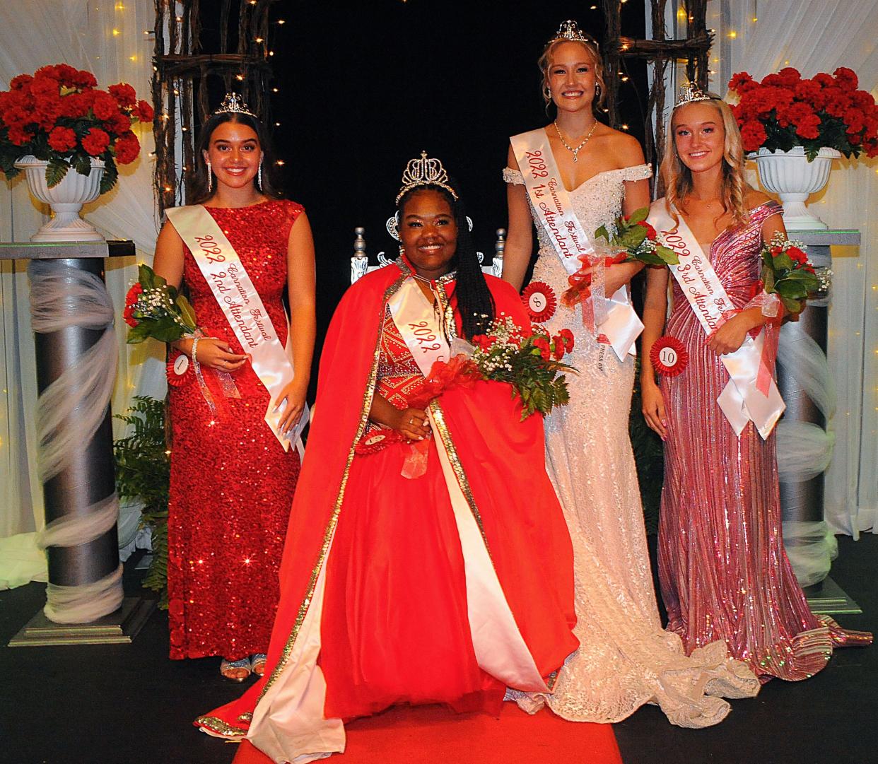 Kayla Martin sits on her throne as queen of the 62nd Greater Alliance Carnation Festival  on Saturday, July 30, 2022, at Alliance High School. Pictured with her is her court, from left, 2nd attendant Catarina Hagan, 1st attendant Chloe Orzo and 3rd attendant Kenna McElroy.