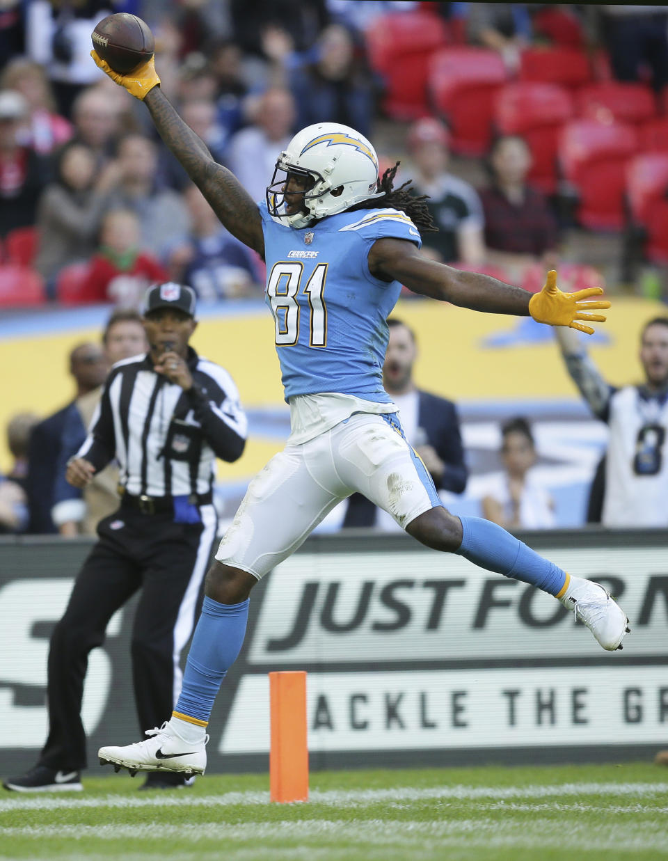Los Angeles Chargers wide receiver Mike Williams (81) celebrates after scoring a touchdown during the second half of an NFL football game against Tennessee Titans at Wembley stadium in London, Sunday, Oct. 21, 2018. (AP Photo/Tim Ireland)