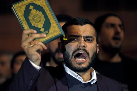 A supporter of Islamic Action Front party holds up a copy of the Koran as he shouts slogans as he takes part in a sit-in near the New Zealand Consulate against shooting at the Al Noor mosque in Christchurch, in Amman, Jordan, March 15, 2019. REUTERS/Muhammad Hamed