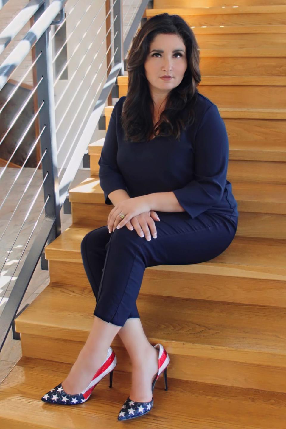 A posed picture of Michelle Pozzie sitting on some stairs