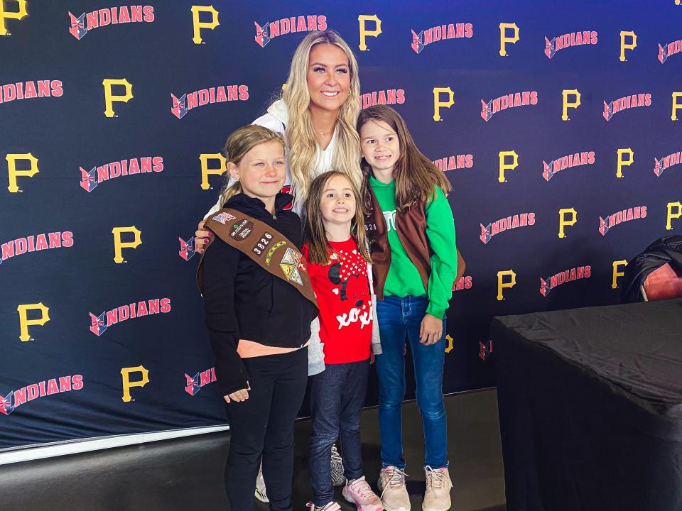 IU women's basketball standout and former IndyStar Miss Basketball Sydney Parrish poses with young fans at an Indianapolis Indians game as part of an NIL partnership the team has with some college athletes.