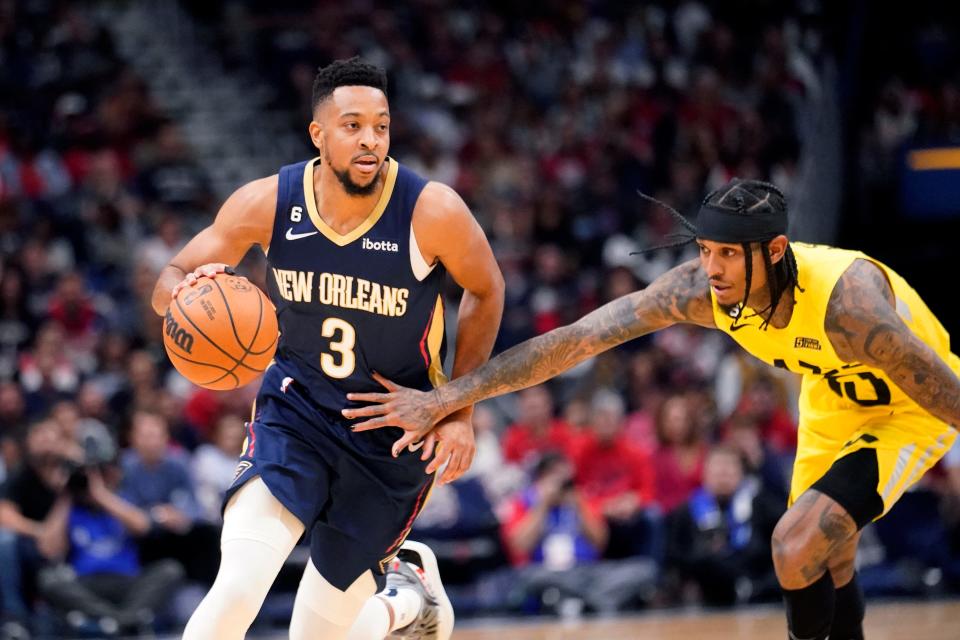 New Orleans Pelicans guard CJ McCollum (3) moves the ball down court against Utah Jazz guard Jordan Clarkson in the first half in New Orleans, Sunday, Oct. 23, 2022.