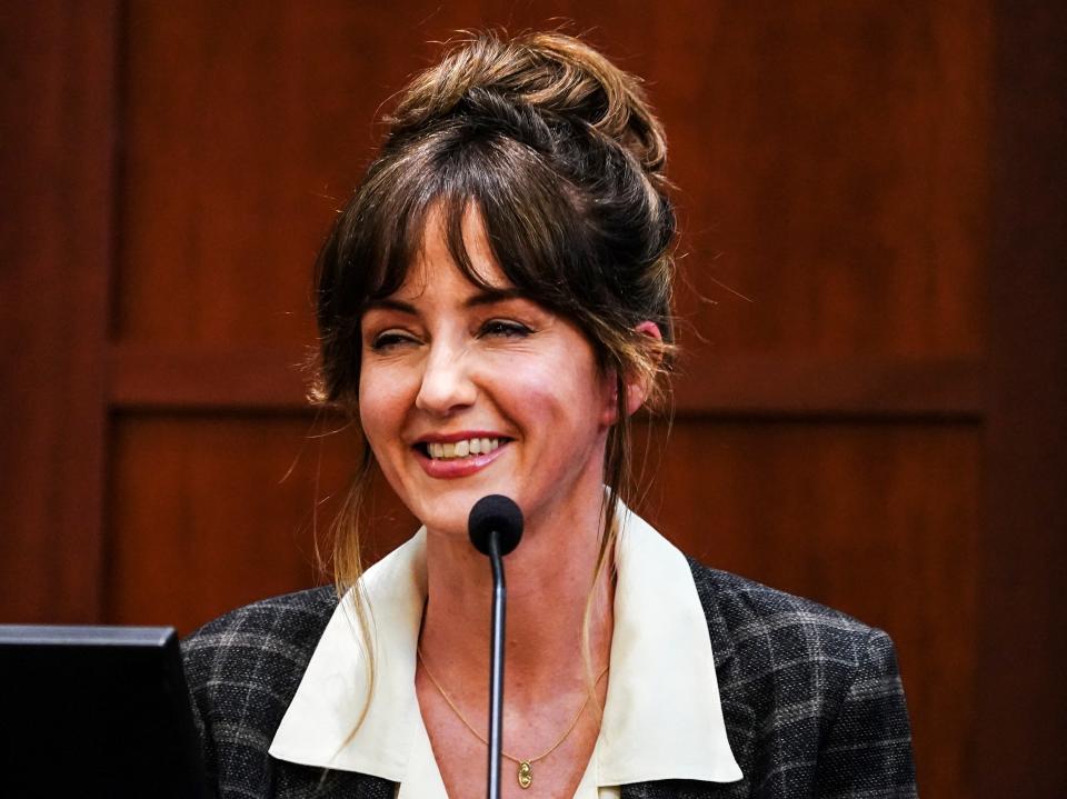 Johnny Depp’s friend Gina Deuters laughs on the stand (REUTERS)