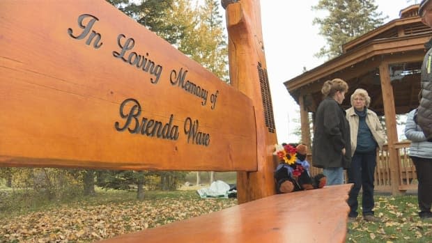 Brenda Ware’s family and friends gathered for the unveiling of the hand-carved bench in her honour Saturday.  (Terri Trembath/CBC - image credit)