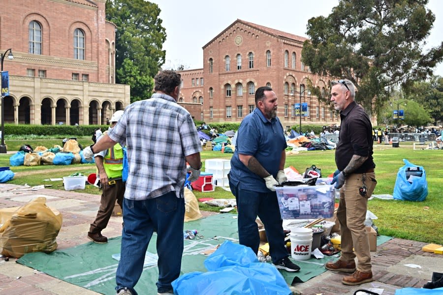Workers clean up the University of California, Los Angeles (UCLA) campus after police evicted pro-Palestinian students, in Los Angeles, California, early on May 2, 2024. Hundreds of police tore down protest barricades and began arresting students early Thursday at the University of California, Los Angeles – the latest flashpoint in an eruption of protest on US campuses over Israel’s war against Hamas in Gaza. (Photo by Frederic J. Brown / AFP) (Photo by FREDERIC J. BROWN/AFP via Getty Images)