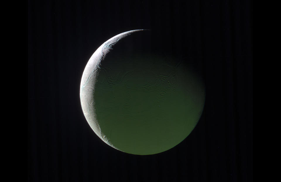 <p>The brightly lit limb of a crescent Enceladus looks ethereal against the blackness of space. The rest of the moon, lit by light reflected from Saturn, presents a ghostly appearance.This image is a composite of images taken with the Cassini spacecraft narrow-angle camera on March 29, 2017, using filters that allow infrared, green, and ultraviolet light. (Photo: NASA/JPL-Caltech/Space Science Institute) </p>