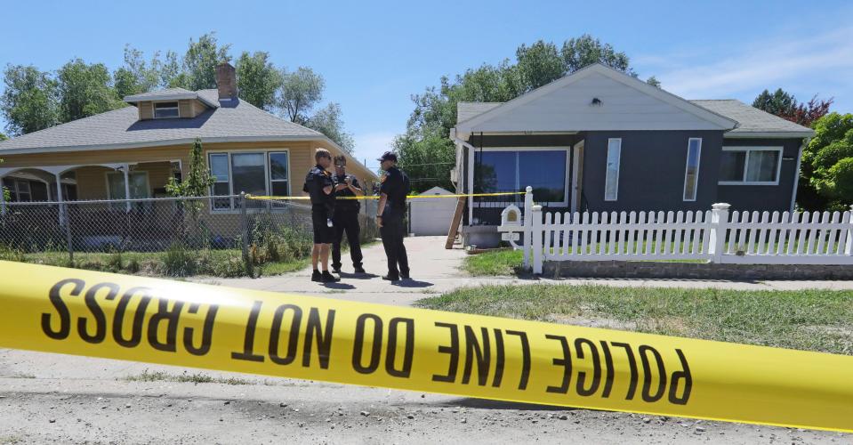 Police officers stand in front of the home, right, of Ayoola A. Ajayi Friday, June 28, 2019, in Salt Lake City. Authorities are filing murder and kidnapping charges in the death of a Utah college student who disappeared 11 days ago. Salt Lake City police chief Mike Brown said 31-year-old Ajayi will be charged with aggravated murder, kidnaping and desecration of a body in the death of 23-year-old Mackenzie Lueck. (AP Photo/Rick Bowmer) ORG XMIT: UTRB106