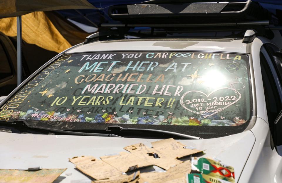 Lily and Jeronie Alcantara’s car is seen with window paint spelling out their love story at their campsite during the Coachella Valley Music and Arts Festival in Indio, Calif., Sunday, April 17, 2022.
