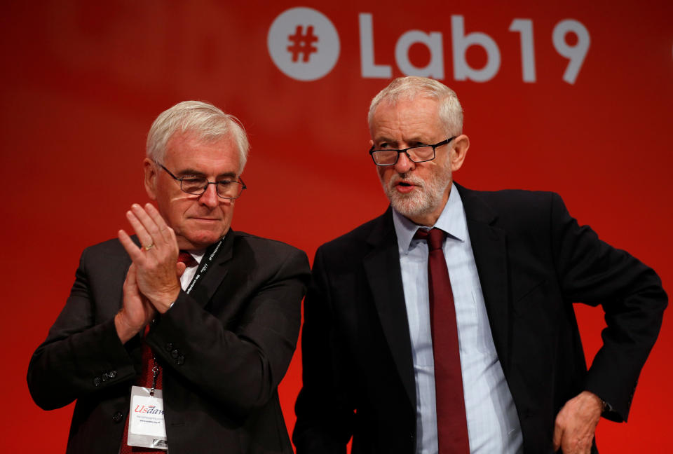 British Labour MP John McDonnell applauds next to Labour Party leader Jeremy Corbyn at the Labour party annual conference in Brighton, Britain September 24, 2019.  REUTERS/Peter Nicholls