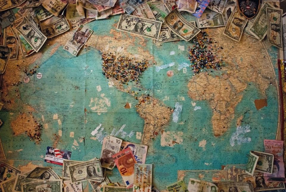picture of world map with currency scattered around