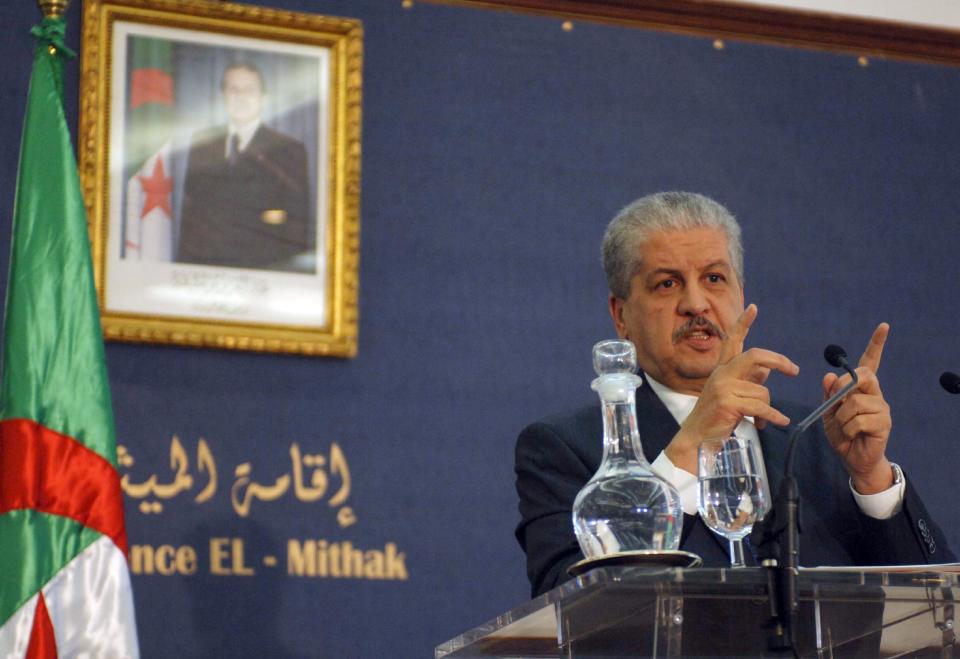FILE - This Monday Jan. 21, 2013, file photo shows Algerian Prime Minister Abdelmalek Sellal answering questions during a press conference held in Algiers, Algeria. At left is a portrait of Algerian President, Abdelaziz Bouteklika. The Algerian government announced Friday, Jan. 17, 2014, the official date of its presidential elections, yet with just 90 days to go before one of the most important votes in its history, it is not yet clear who is even running. The presidential elections, now scheduled for April 17, could possibly see the handing over of power to a new generation and for the first time Algeria would be led by someone who didn’t fight in the 1958-1962 war for independence against France. (AP Photo/Sidali Djarboub, File)