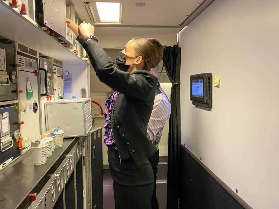 An Air New Zealand flight attendant prepares for passengers to board the plane.