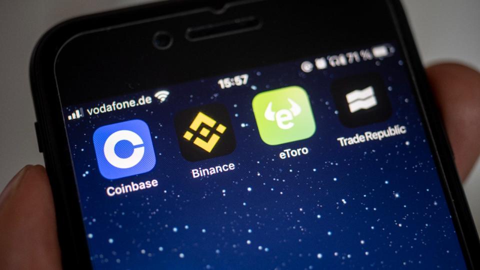 An image of the Binance and Coinbase apps on a phone