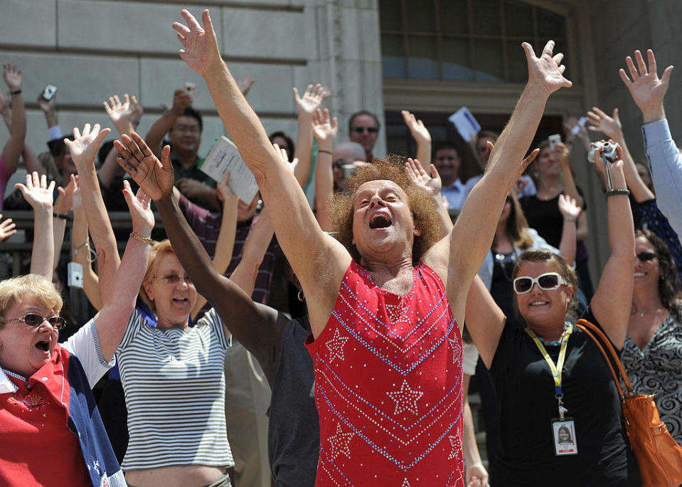 Fitness advocate Richard Simmons, wearing his signature shorts and tanktop, leads Capitol Hill staff and visitors through an exercise routine July 24, 2004 in Washington, DC.  / Credit: TIM SLOAN/AFP/Getty Images