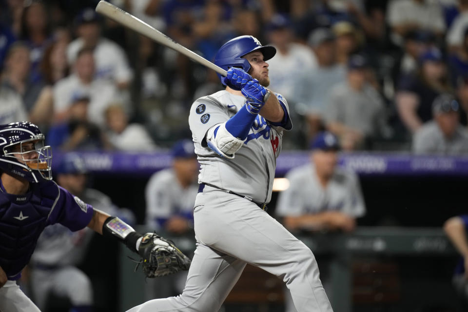 Los Angeles Dodgers' Max Muncy watches his two-run home run off Colorado Rockies relief pitcher Zac Rosscup during the ninth inning of a baseball game Saturday, July 17, 2021, in Denver. The Dodgers won 9-2. (AP Photo/David Zalubowski)