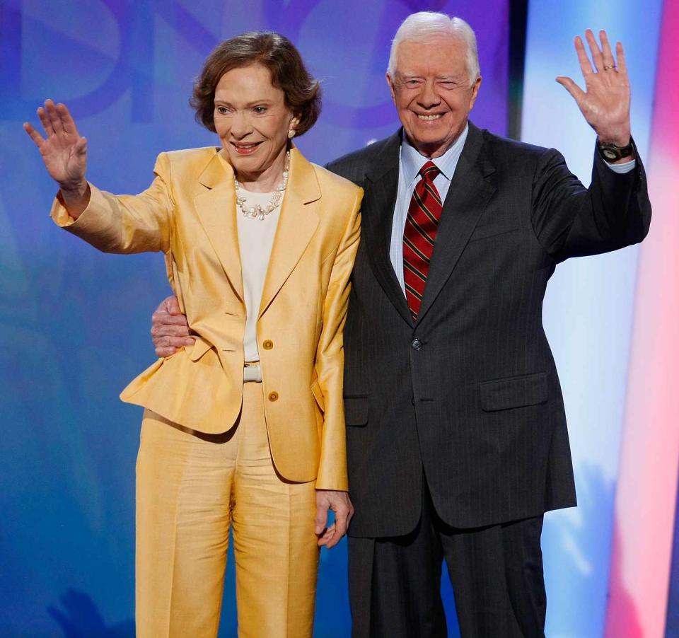 Former U.S. President Jimmy Carter (R) and former first lady Rosalynn Carter wave on stage during day one of the Democratic National Convention (DNC) at the Pepsi Center August 25, 2008 in Denver, Colorado. The DNC, where U.S. Sen. Barack Obama (D-IL) will be officially nominated as the Democratic candidate for U.S. president, starts today and finishes August 28th