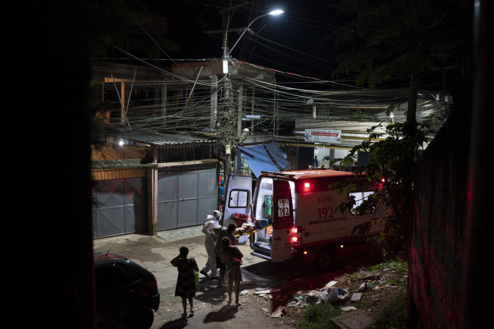 FILE - In this April 7, 2021, file photo, Mobile Emergency Care Service (SAMU) workers carry an elderly COVID-19 patient to an ambulance in Duque de Caxias, Rio de Janeiro state, Brazil. Nations around the world set new records Thursday, April 8, for COVID-19 deaths and new coronavirus infections, and the disease surged even in some countries that have kept the virus in check. Brazil became just the third country, after the U.S. and Peru, to report a 24-hour tally of COVID-19 deaths exceeding 4,000. (AP Photo/Felipe Dana, File)