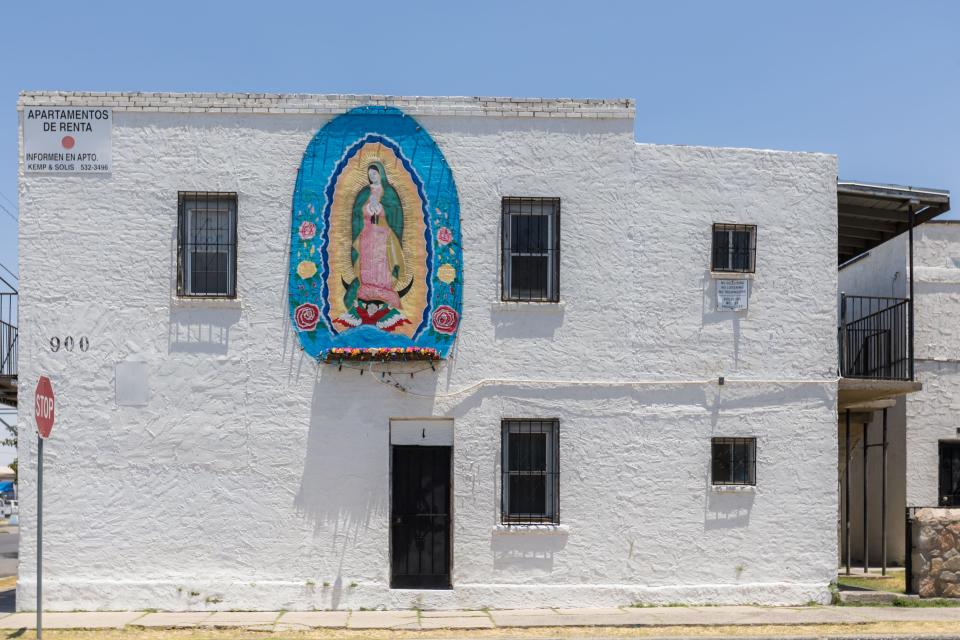 "La Virgen de Guadalupe" was painted by Felipe Adame, assisted by Jesus "Machido" Hernandez in 1981, restored in 1991. The Mural is located at the exterior west wall of an apartment complex at 900 S. Ochoa St. in Segundo Barrio in El Paso, Texas.