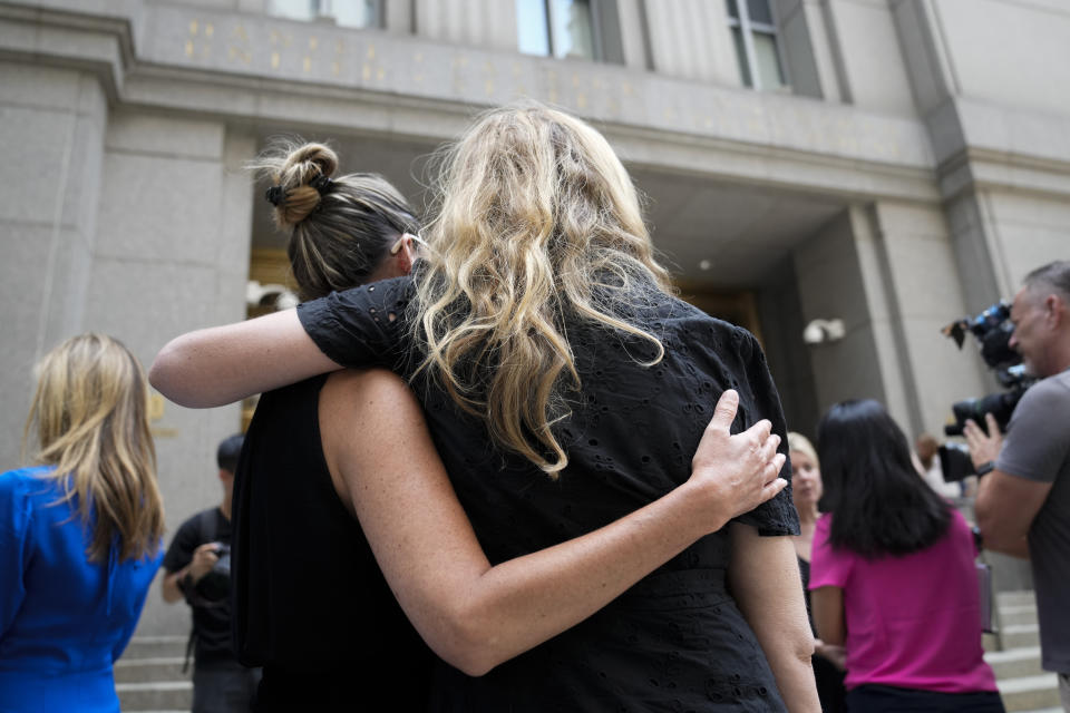 Sexual assault victims embrace as their compatriots speak to members of the media after sentencing proceedings concluded for convicted sex offender Robert Hadden outside Federal Court, Tuesday, July 25, 2023, in New York. (AP Photo/John Minchillo)