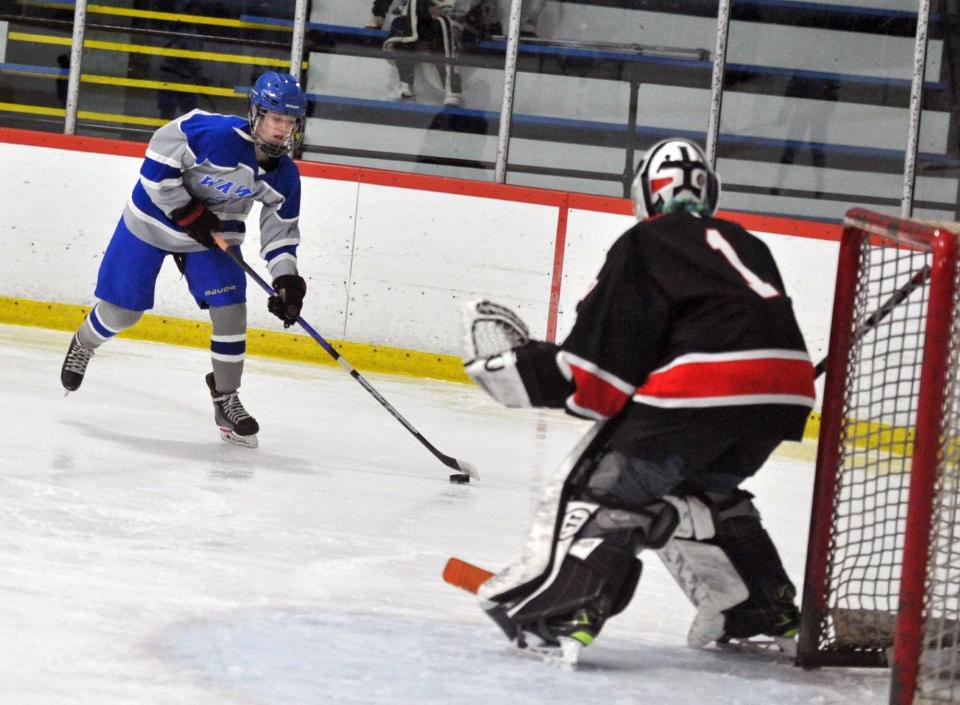 Braintree's Nora Shea, left, lines up her shot on Wellesley goalie Magnus Saunders, right, during high school girls hockey at the Zapustas Arena in Randolph, Wednesday, Jan. 31, 2024.