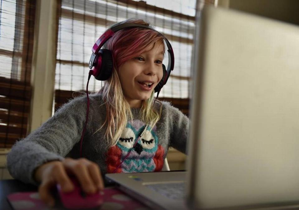In a 2016 file photo, Avery Jackson, shown engaged in a video game, had been trolled online after going public as a transgender girl. “I don’t care if I’m transgender,” she says. “I’m just out there, a normal human being changing the world.”