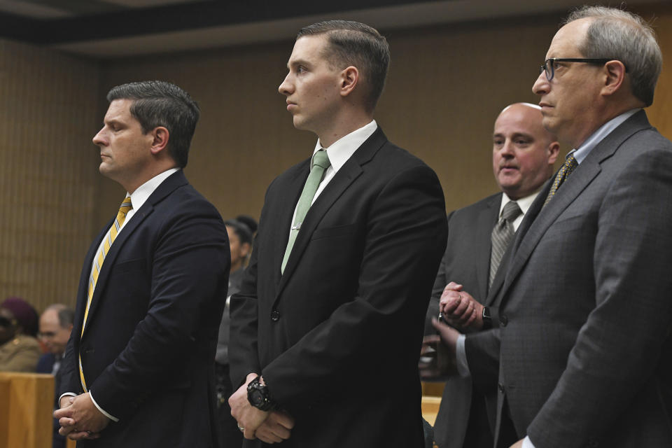 State Trooper Brian North, center, listens as a jury reads a verdict of not guilty on all counts in Connecticut Superior Court in Milford, Conn., Friday, March 15, 2024. North was acquitted of all charges Friday in the death of Mubarak Soulemane, a community college student with mental illness who was shot as he sat behind the wheel of a stolen car holding a kitchen knife. (Ned Gerard/Hearst Connecticut Media via AP, Pool)