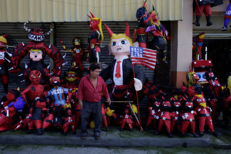 A pinata representing U.S. President-elect Donald Trump as a devil is seen outside a pinata store before it is set on fire at the traditional Burning of the Devil festival, ahead of Christmas in Guatemala City, Guatemala, December 7, 2016. REUTERS/Luis Echeverria