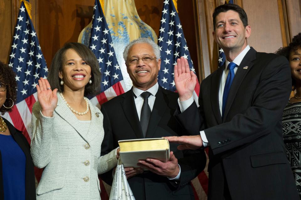 Former House Speaker Paul Ryan (right) administers the House oath of office to Rep. Lisa Blunt Rochester, D-Del., as her father, Ted Blunt, stands next to her during a mock swearing-in ceremony on Capitol Hill in Washington on Jan. 3, 2017.