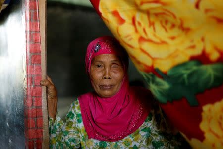 An evacuated woman stands at her makeshift tent at an evacuation center outside Marawi while government forces still fighting insurgents from the Maute group in Marawi, Philippines June 26, 2017. REUTERS/Jorge Silva