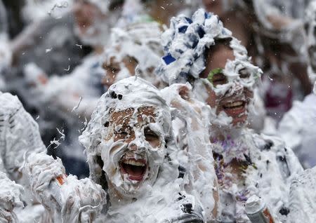 Students from St Andrews University are covered in foam as they take part in the traditional 'Raisin Weekend' in the Lower College Lawn, at St Andrews in Scotland, Britain October 17, 2016. REUTERS/Russell Cheyne