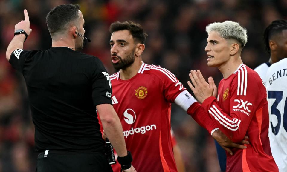 <span>Bruno Fernandes, centre, protests to Chris Kavanagh after being sent off in Manchester United’s 3-0 loss to Tottenham at Old Trafford on Sunday.</span><span>Photograph: Paul Ellis/AFP/Getty Images</span>