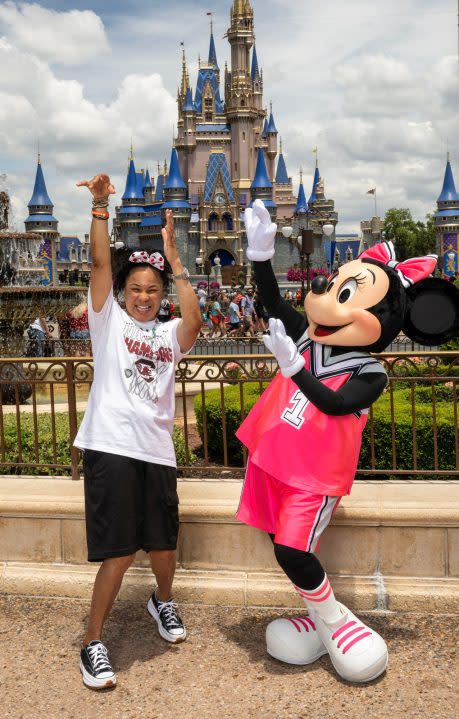 (April 27, 2024) Minnie Mouse greets South Carolina women’s basketball head coach Dawn Staley during her visit to Walt Disney World Resort in Lake Buena Vista Fla., on Saturday. Staley was at Walt Disney World to celebrate her basketball team’s recent national championship by riding in a parade down Main Street, U.S.A., that featured streamers, fireworks, Disney characters and cheering guests. (Kent Phillips, photographer)