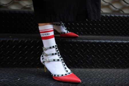 Makiko Oshino, a Nissan employee, shows her shoes at the Manhattan borough of New York, U.S., September 3, 2018. REUTERS/Caitlin Ochs