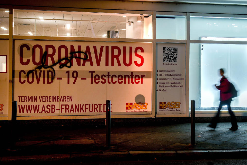 A woman walks past an abandoned Coronavirus testing center in Frankfurt, Germany, Thursday, Nov. 18, 2021. COVID-19 infections in Germany reached a new record high on Thursday. (AP Photo/Michael Probst)