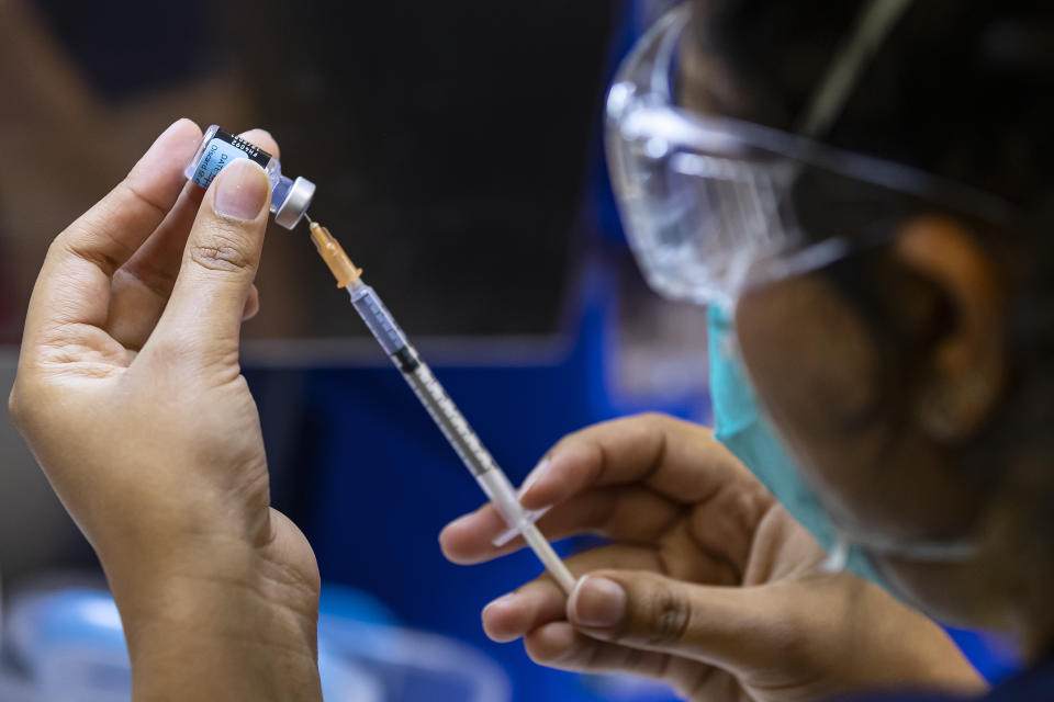 A health care worker prepares a Pfizer vaccine in Melbourne. Source: AAP