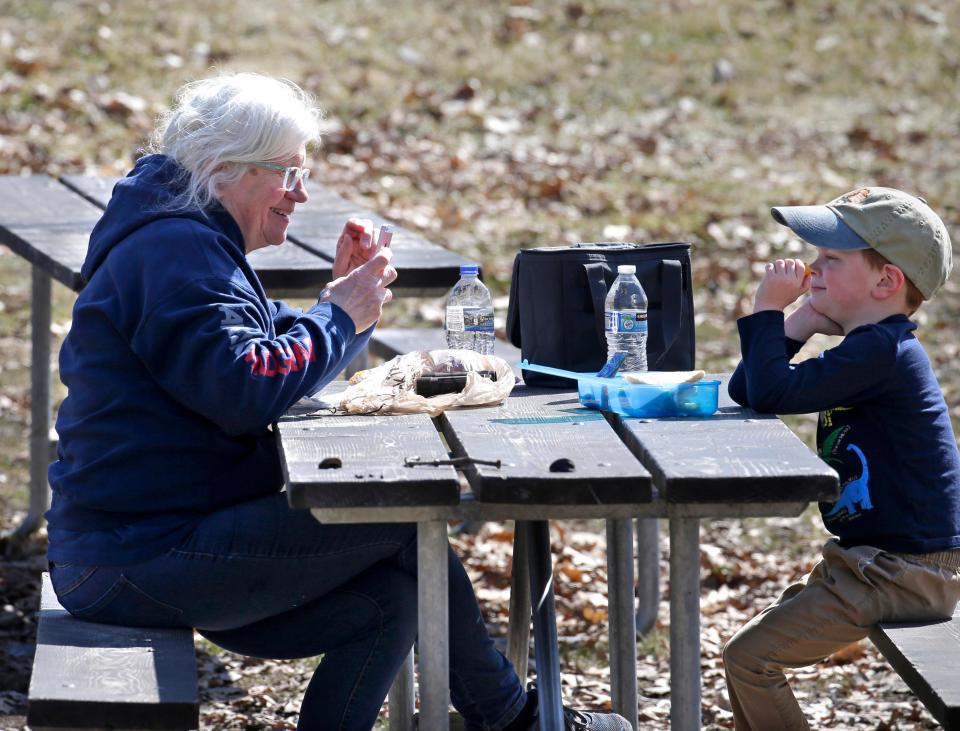 Janet Hoppe enjoys an outdoor lunch with her grandson as they spend time at The Kettle Moraine State Forest - Lapham Peak, during the COVID-19 pandemic.