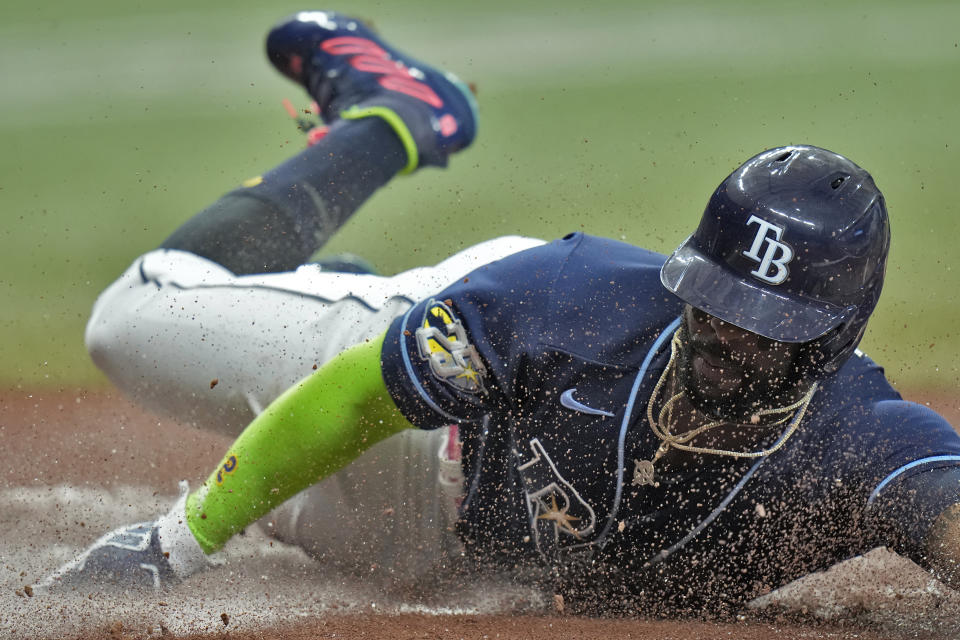 Tampa Bay Rays' Yandy Diaz slides home safely scoring on an RBI single by Randy Arozarena off Kansas City Royals pitcher Jose Cuas during the first inning of a baseball game Thursday, June 22, 2023, in St. Petersburg, Fla. (AP Photo/Chris O'Meara)