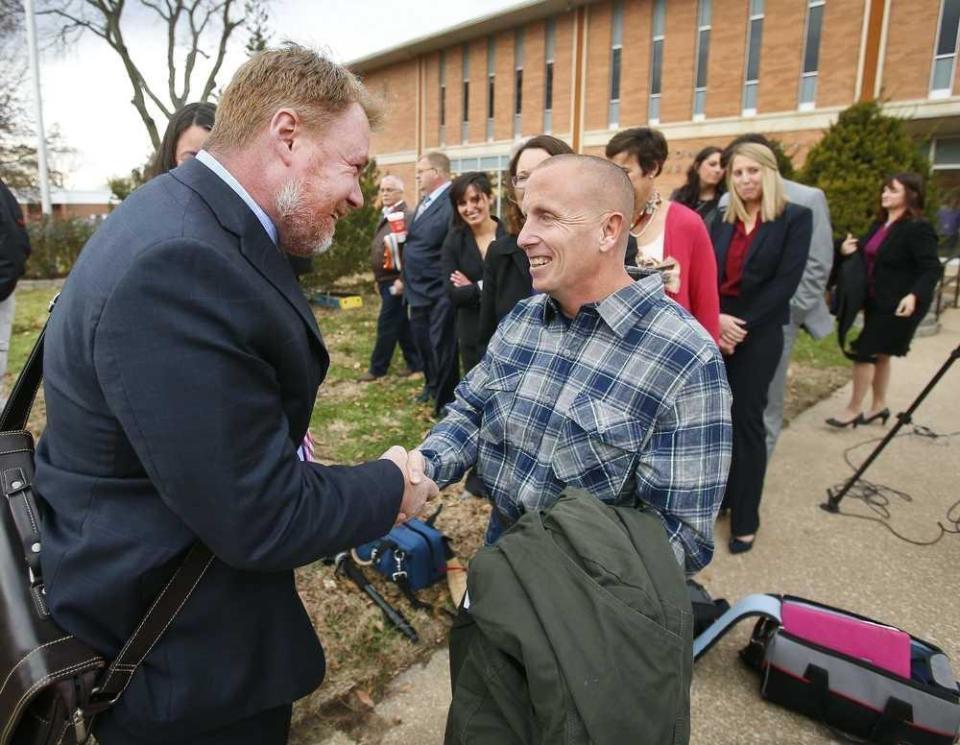 Floyd Bledsoe, right, is greeted by Oliver Burnette, executive director of the Midwest Innocence Project, in 2015 after he was proven innocent of the 1999 murder of his sister-in-law, 14-year-old Camille Arfmann.