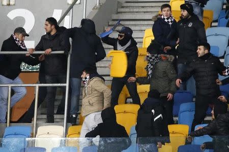 Football Soccer - FC Dynamo Kyiv v Besiktas - UEFA Champions League Group Stage - Group B - NSC Olimpiyskiy Stadium, Kiev, Ukraine - 6/12/16. Besiktas' fans throw plastic chairs during the match. REUTERS/Gleb Garanich