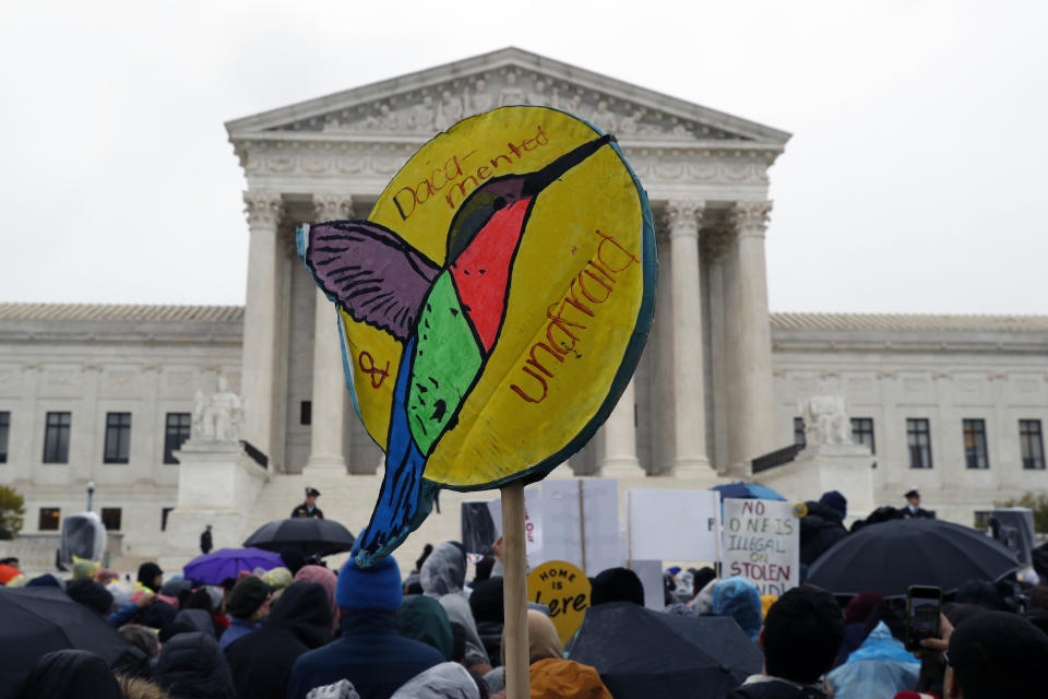 People rally outside the Supreme Court as oral arguments are heard in the case of President Trump's decision to end the Obama-era, Deferred Action for Childhood Arrivals program (DACA), Tuesday, Nov. 12, 2019, at the Supreme Court in Washington. (AP Photo/Jacquelyn Martin)