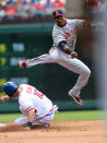 ARLINGTON, TX - MAY 12: Erick Aybar #2 of the Los Angeles Angels of Anaheim turns the double play as Michael Young #10 of the Texas Rangers is out at 2nd base on May 12, 2012 in Arlington, Texas. (Photo by Layne Murdoch/Getty Images)