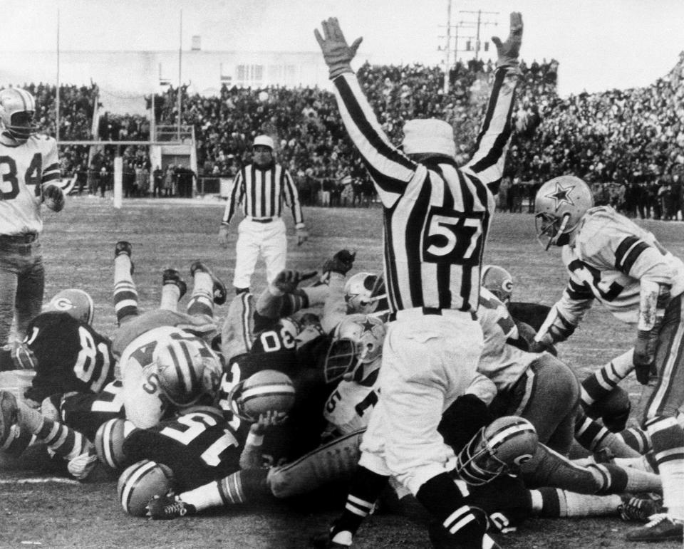 Green Bay Packers quarterback Bart Starr crosses the goal line to score the winning touchdown against the Dallas Cowboys to bring the Packers their third consecutive NFL championship.