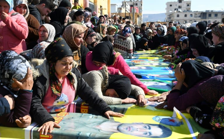 Syrian Kurds attend a funeral ceremony on February 18, 2018 in the northern town of Afrin for Kurdish YPG fighters reportedly killed in clashes on the border with Turkey