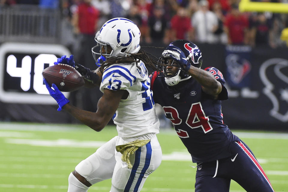 FILE - Indianapolis Colts wide receiver T.Y. Hilton (13) makes a catch in front of Houston Texans cornerback Johnathan Joseph (24) during the second half of an NFL football game in Houston, in this Thursday, Nov. 21, 2019, file photo. Colts receiver T.Y. Hilton was back on the practice field for Wednesday's, Oct. 13, 2021, light workout. The four-time Pro Bowler has been designated for return from injured reserve after having neck surgery in August and coach Frank Reich is optimistic Hilton will be cleared to play this weekend against the Houston Texans. (AP Photo/Eric Christian Smith, File)